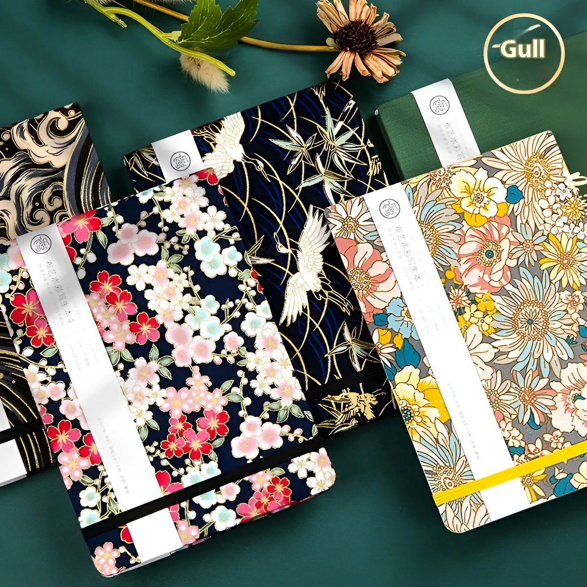 Feiluniao fabric-covered watercolour notebook open on a table with art supplies.
