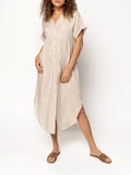 A loose-fitting, solid-colour mid-length casual dress with a front button closure and regular sleeves.