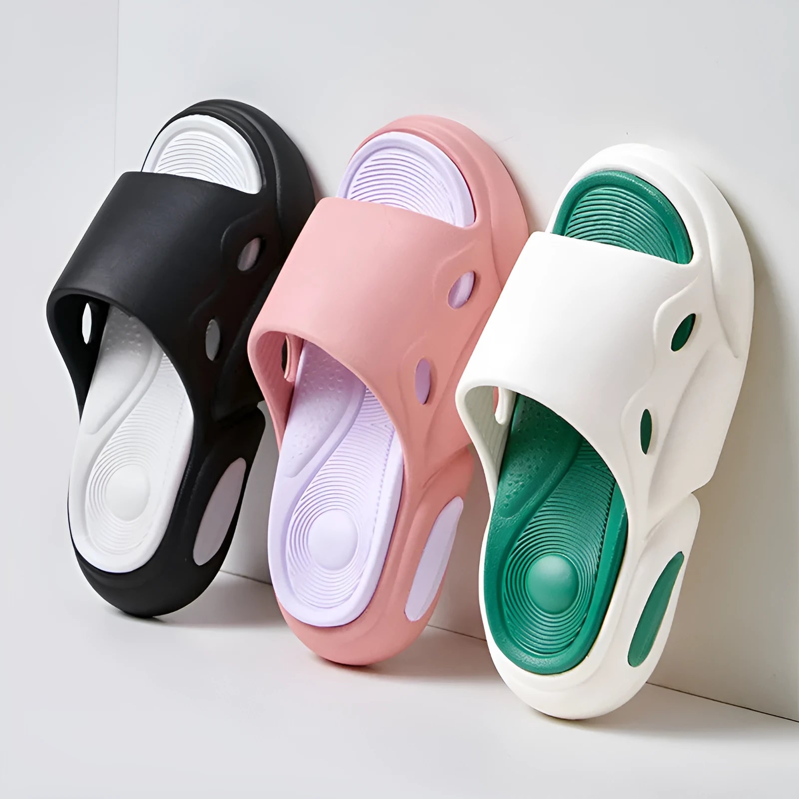 Women's two-colour EVA foam slippers with thick sole in pink and purple, shown on a foot.