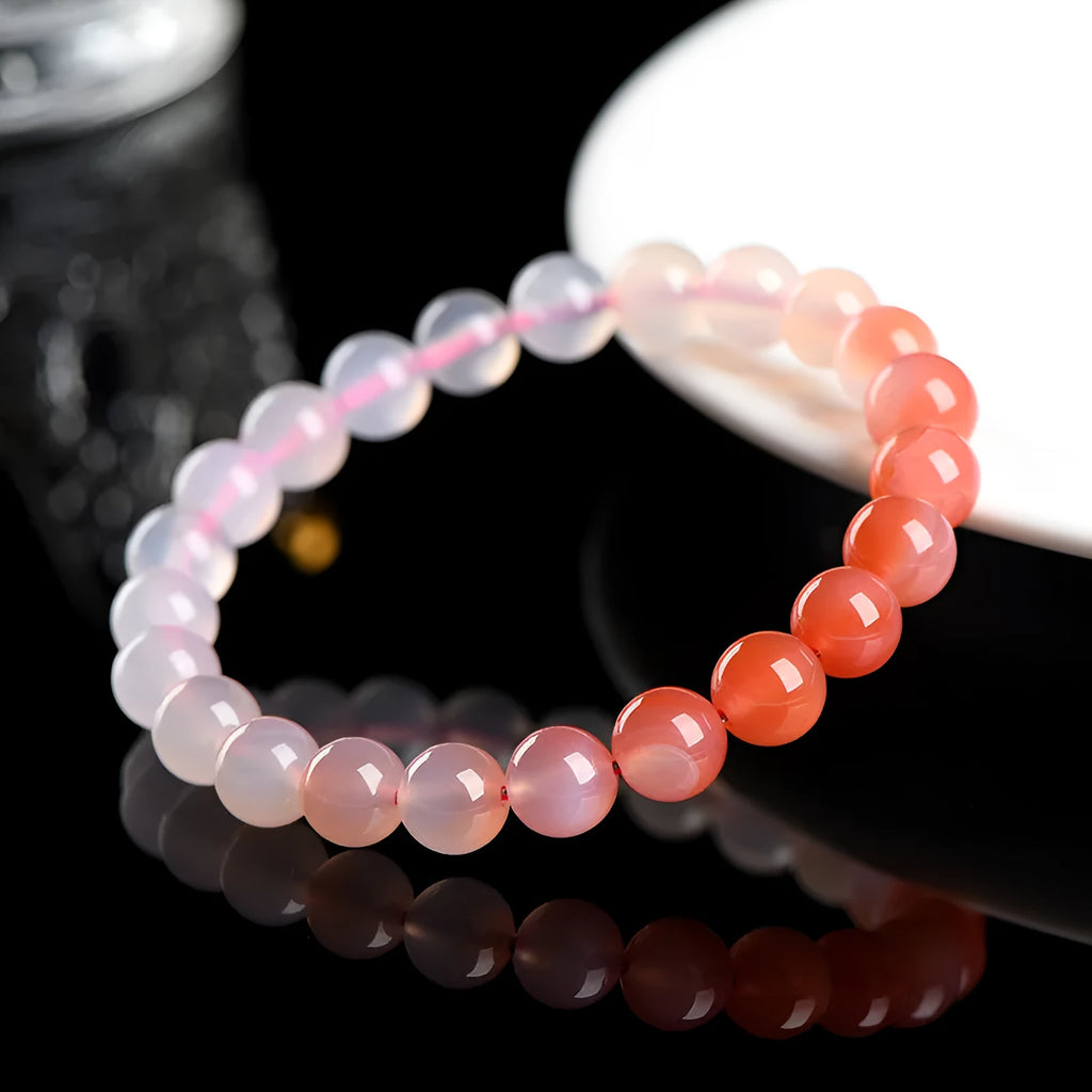 Natural gradient Yanyuan agate bracelet with geometric beads on a wrist, showing colour variation.