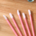 Pack of multi-colour disposable lip brush applicators with black handles and soft flocked tips.