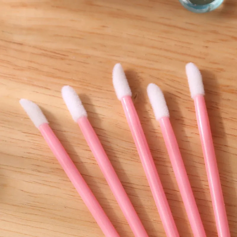 Pack of multi-colour disposable lip brush applicators with black handles and soft flocked tips.