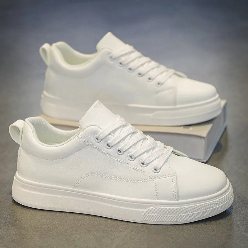 Men's low-top Korean-style sneakers in all black, all white, and black with white bottom colours on a rubber sole