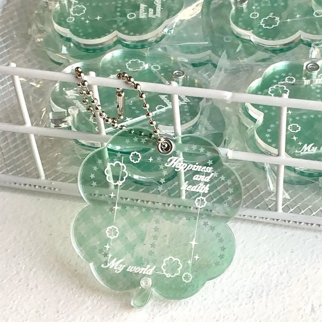 Acrylic four-leaf clover pendant keychain in elegant blue, grass green, and mint green colours.