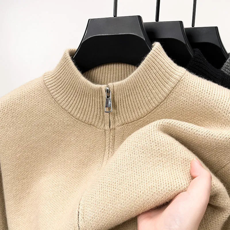 Man wearing a beige stand collar zip-front knitted cardigan with a loose fit.