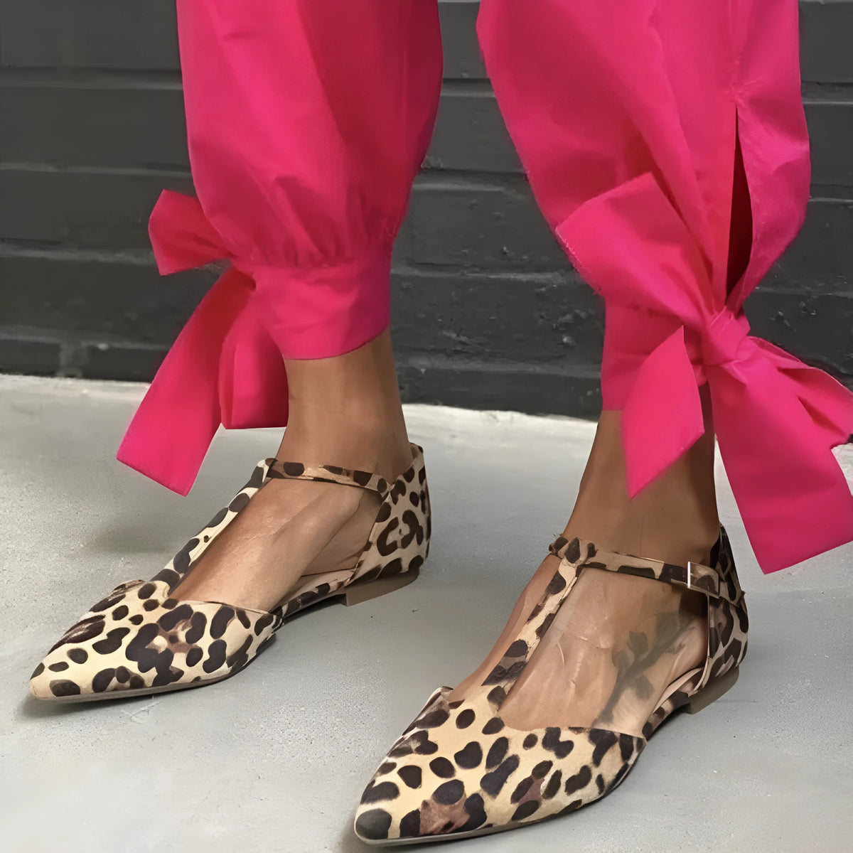 Leopard print women's pumps with a pointed toe, chunky low heel, and an ankle strap.