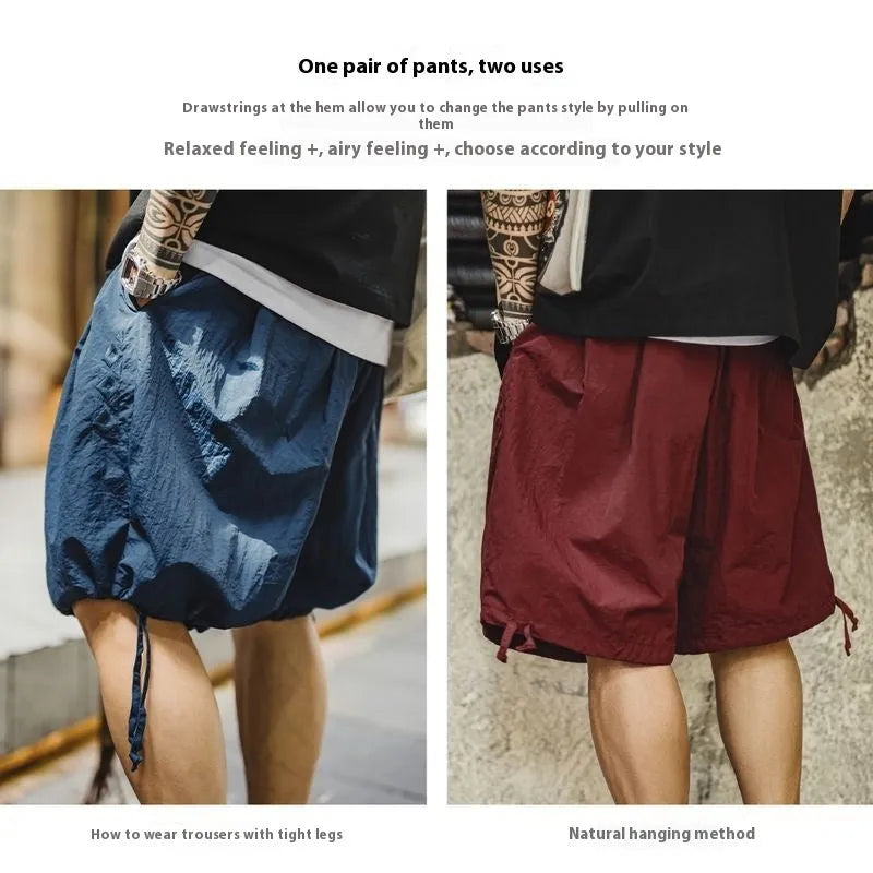 Men's Prussian Blue loose-fit nylon beach shorts with embroidered detail on a white background.