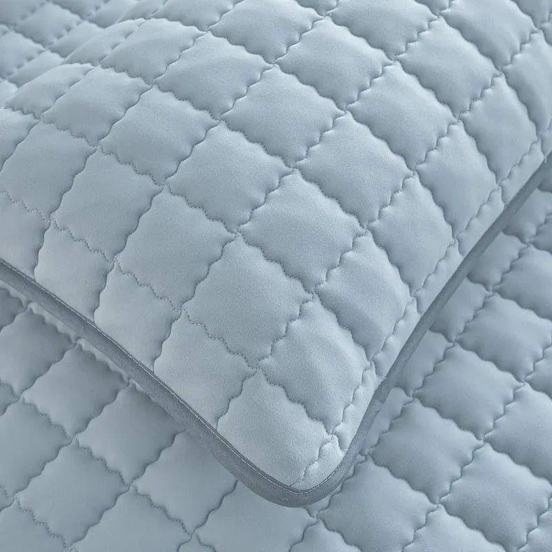 Class A waterproof washed cotton fitted sheet in light grey colour on a bed.