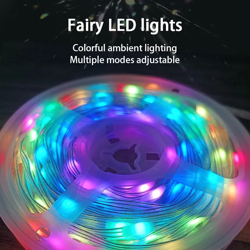 10 metre long LED festival light string with 100 warm white bulbs coiled on a table next to its remote control.