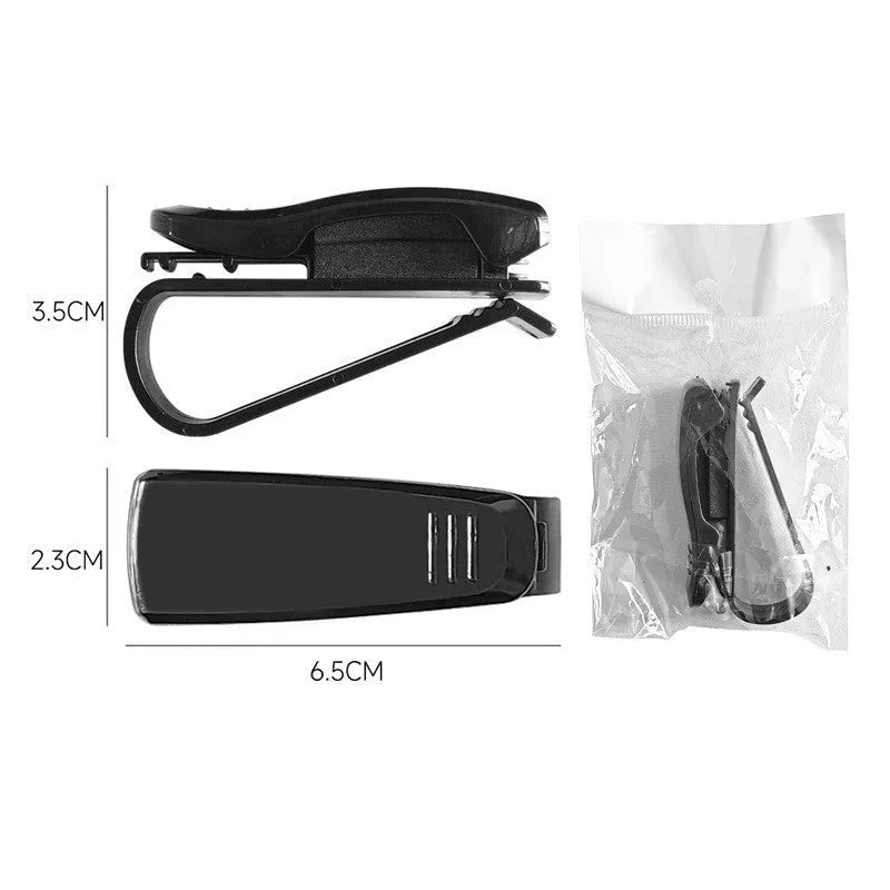Black plastic multifunctional clip for car sunshade holding sunglasses and cards.