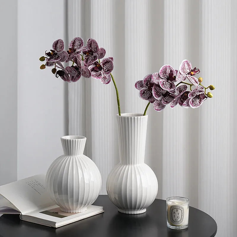 White ceramic ball striped vase in American country style on table with orchid arrangement