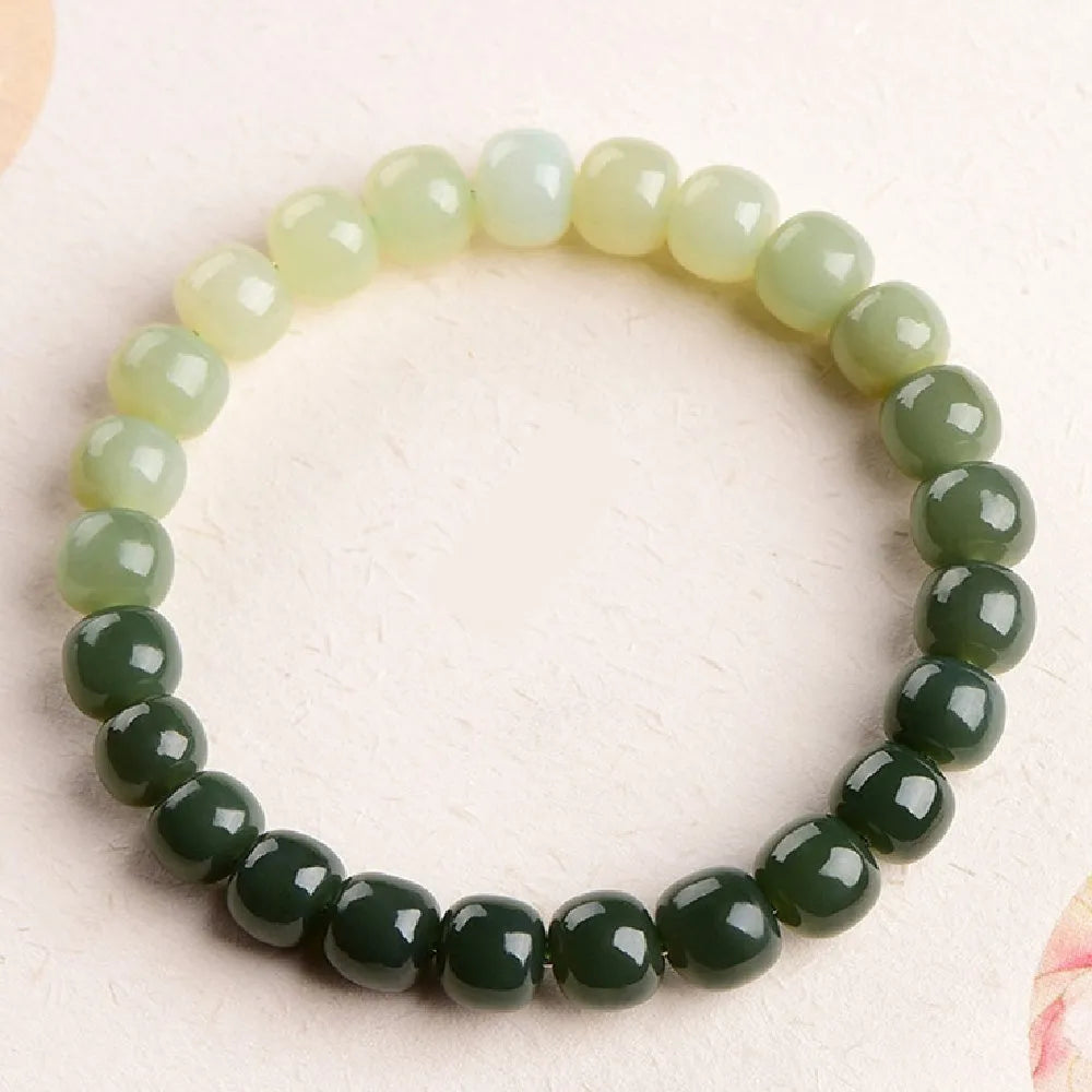 Natural Hetian jade water gradient bracelet with polished beads on an adjustable cord.