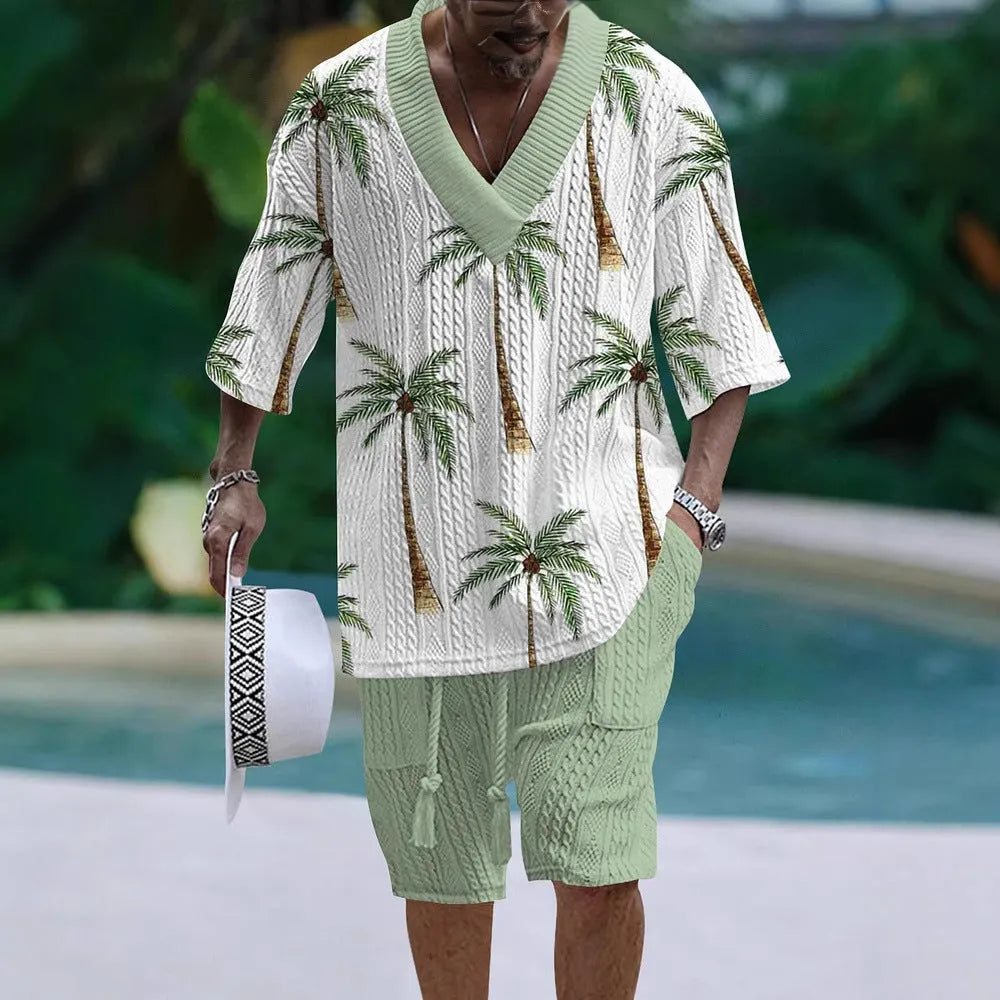 Man wearing a loose light blue short sleeve casual suit top with matching shorts.