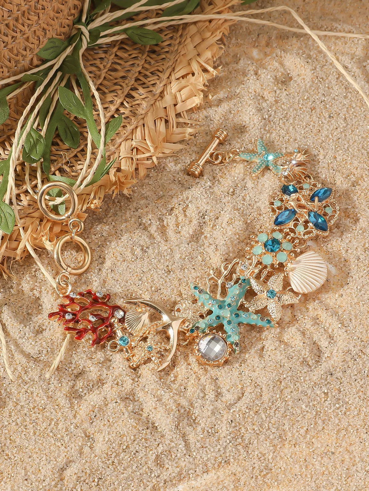 Women's alloy marine bracelet with boat anchor and starfish charms in turquoise, red, or blue coral colours.
