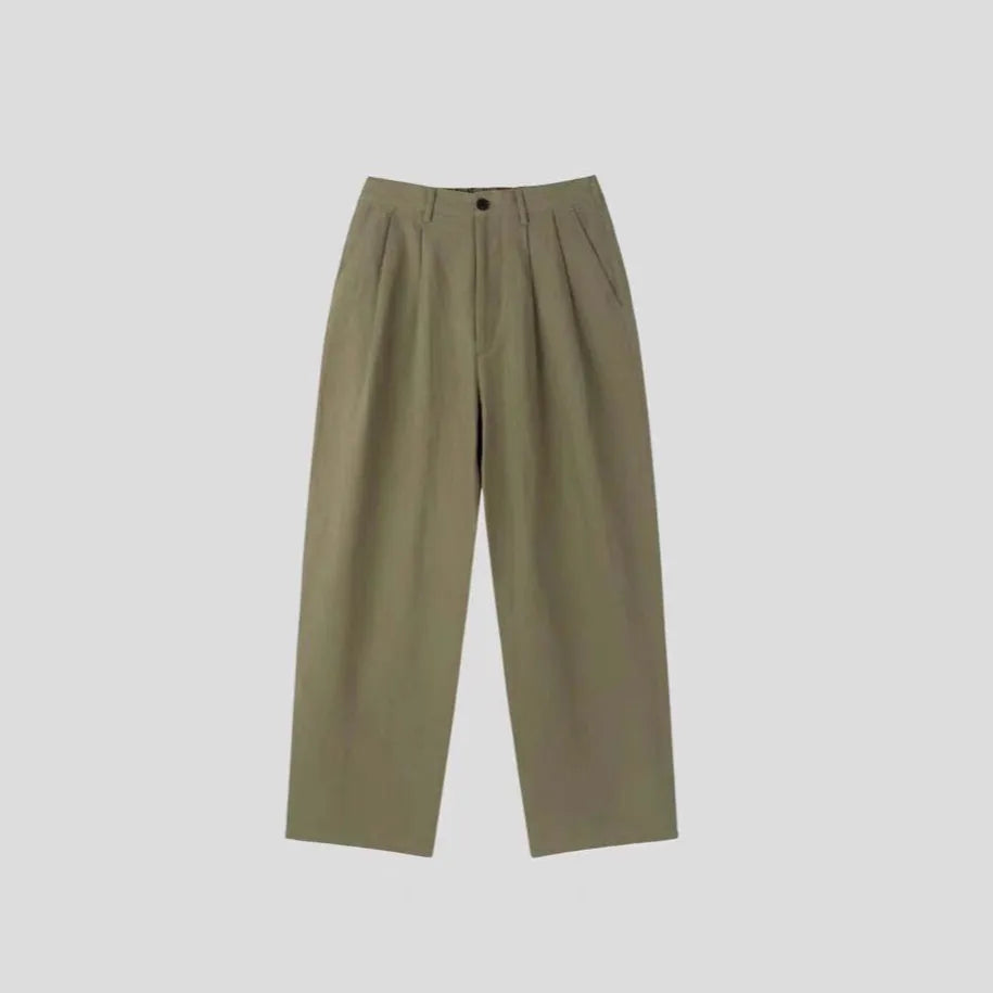 Men's apricot-coloured wide-leg cotton linen trousers with an elastic waistband on a hanger.