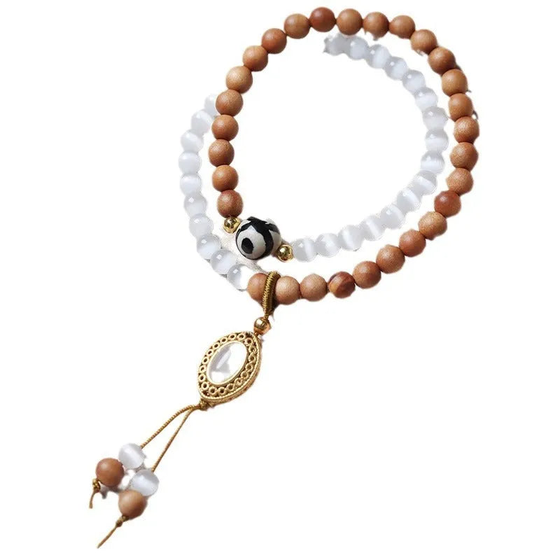 Sandalwood and opal double ring bracelet with polished finish and retro style.