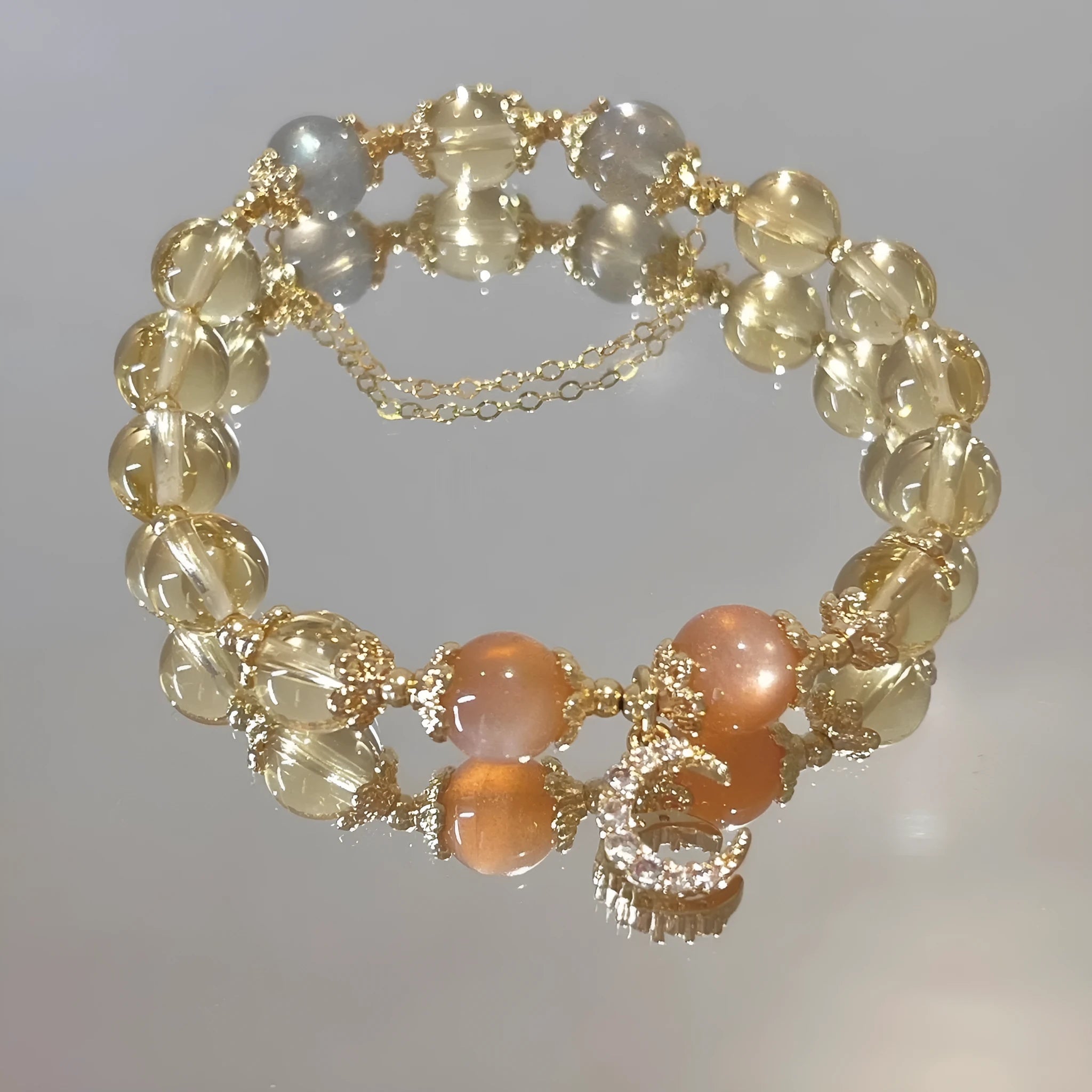 Chinese style women's crystal bracelet with electroplated 14K gilded finish and diamond-shaped moonstone golden sun stone elements