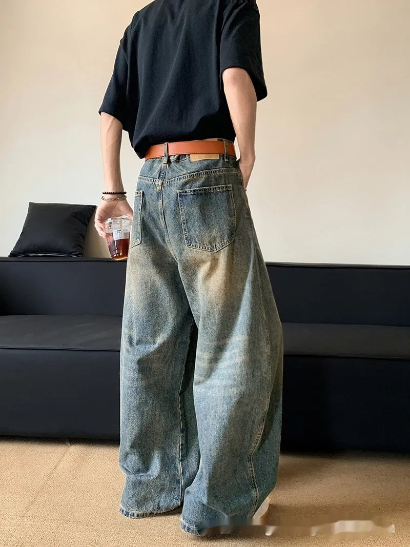 Men's retro blue distressed denim jeans with wide-leg trouser design and micro-elastic fabric