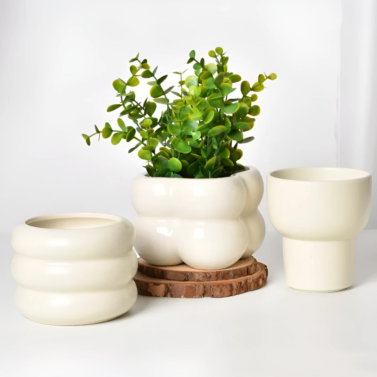 Roman column matte yellow ceramic flower pot on a surface.