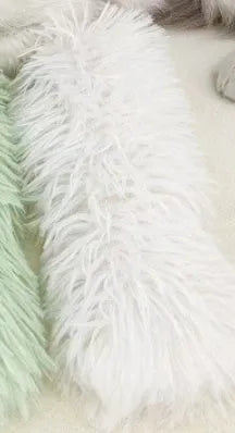 Small green plush pillow cat toy measuring 27cm by 10cm on a plain background