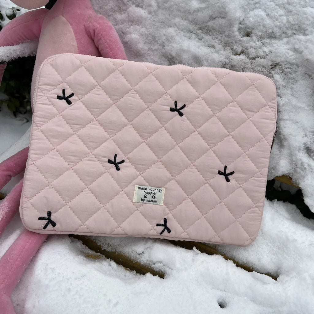 Nylon laptop storage bag with a rhombus-shaped embroidered bow on the front.