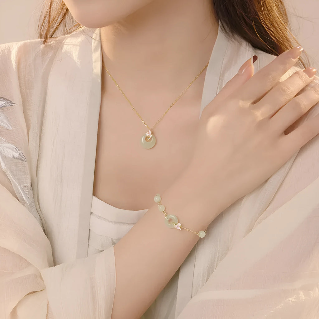 Girl's silver necklace with orchid flower pendant and safety buckle, with matching bracelet.