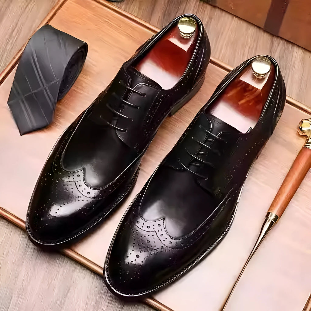 Men's burgundy pointed toe formal shoes with carved brogue patterns and lacing closure