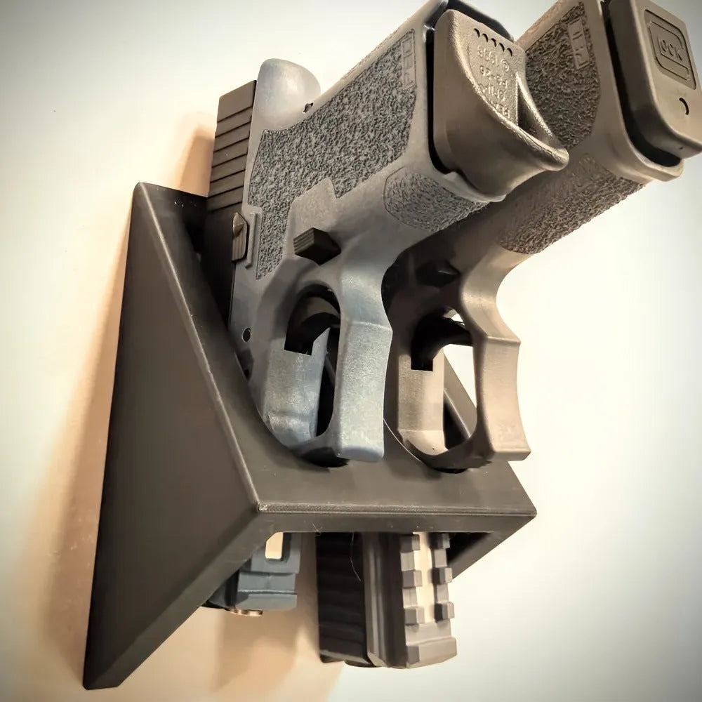 Black punk-style plastic pistol stand for replica firearms measuring 10.85cm tall