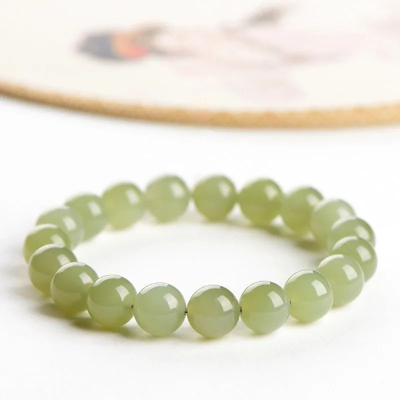 Hetian jade bead bracelet in ice-like clear colour on a white background.