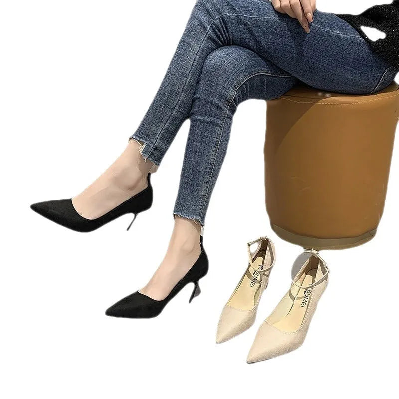 Black women's stiletto pump high heels with a skull-pattern buckle decoration on the front.
