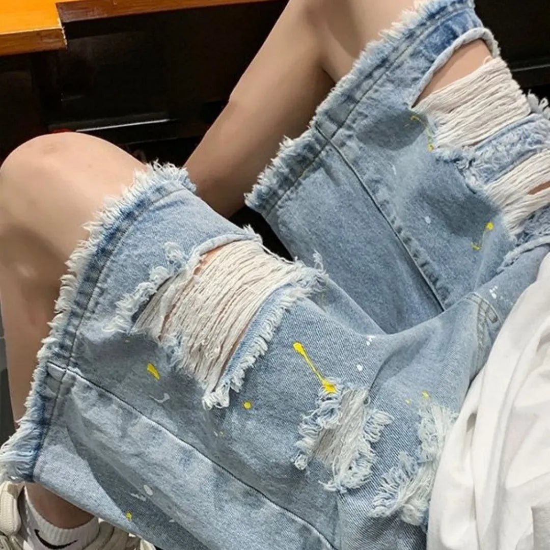 Men's water washed hole denim shorts in black and light blue colours showing loose street style fit