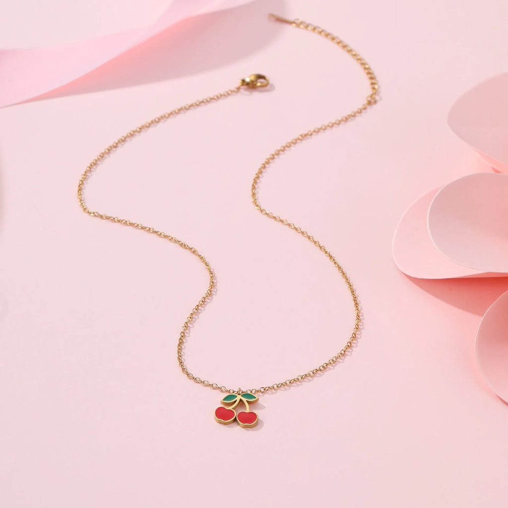 Stainless steel cherry jewellery set showing necklace, bracelet, earrings, and ring with geometric design.