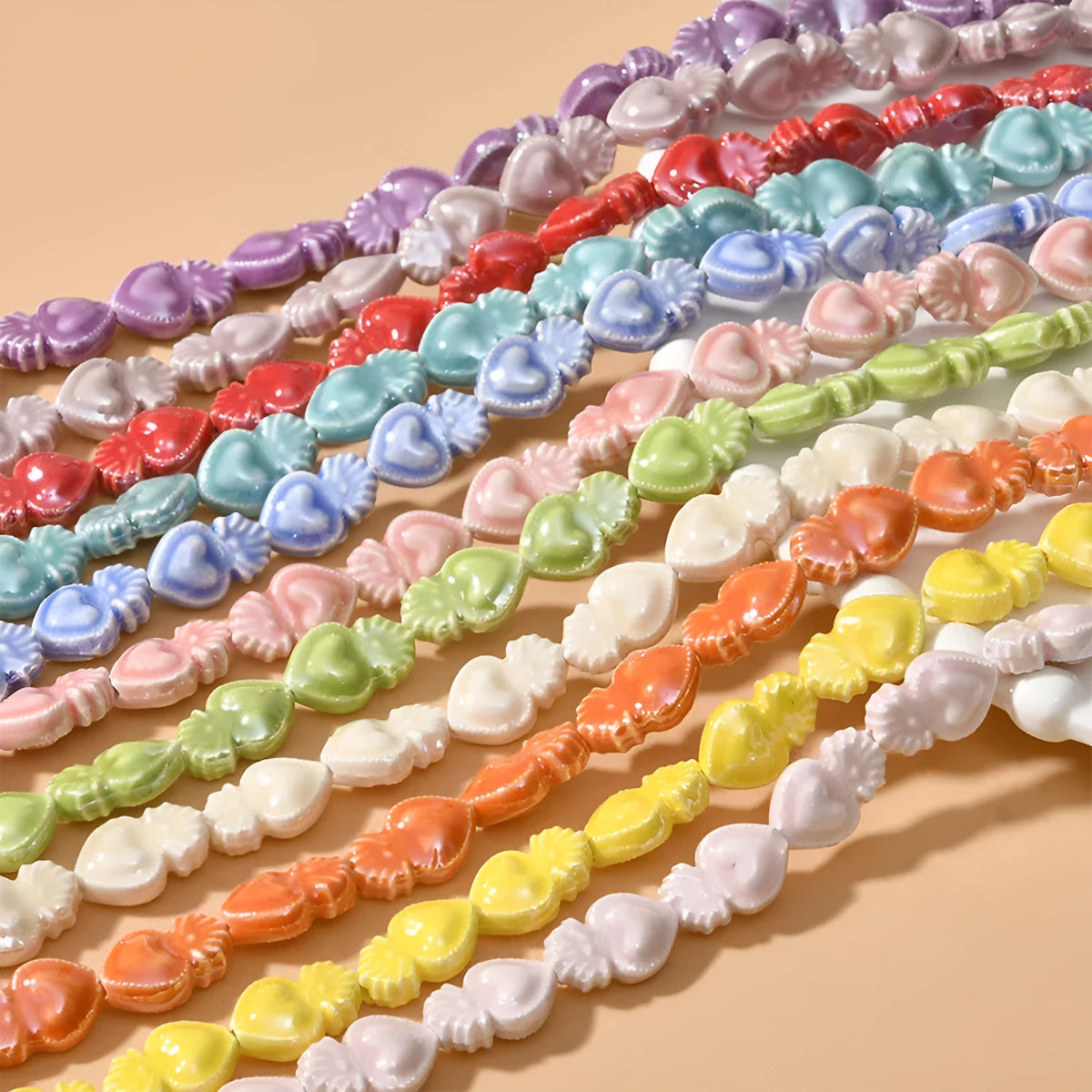 Love heart shaped torch ceramic beads in various colours including cream white, pinks, blues and greens for jewellery making