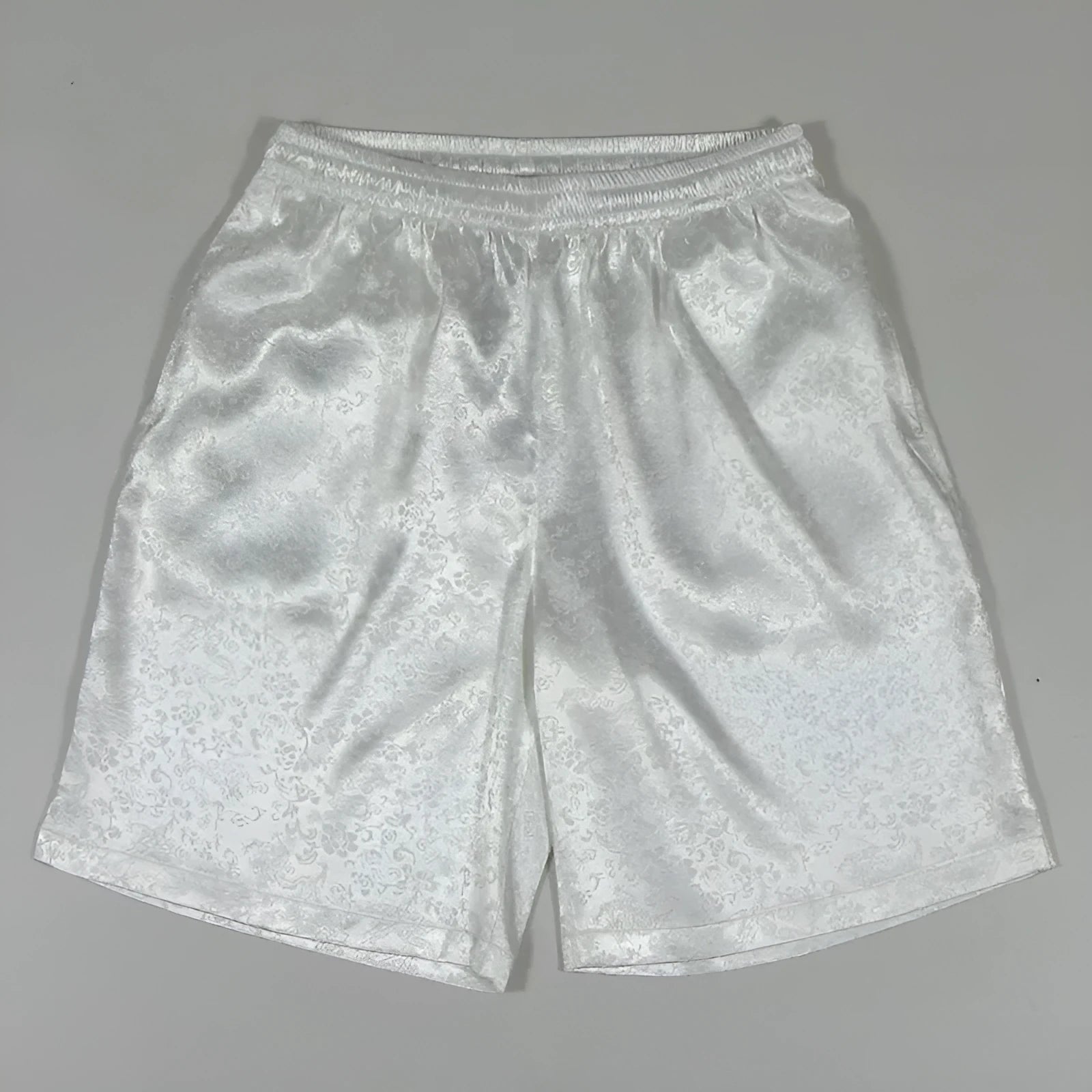 Men's black drawstring waist Tang suit shorts for Tai Chi, shown laid flat.