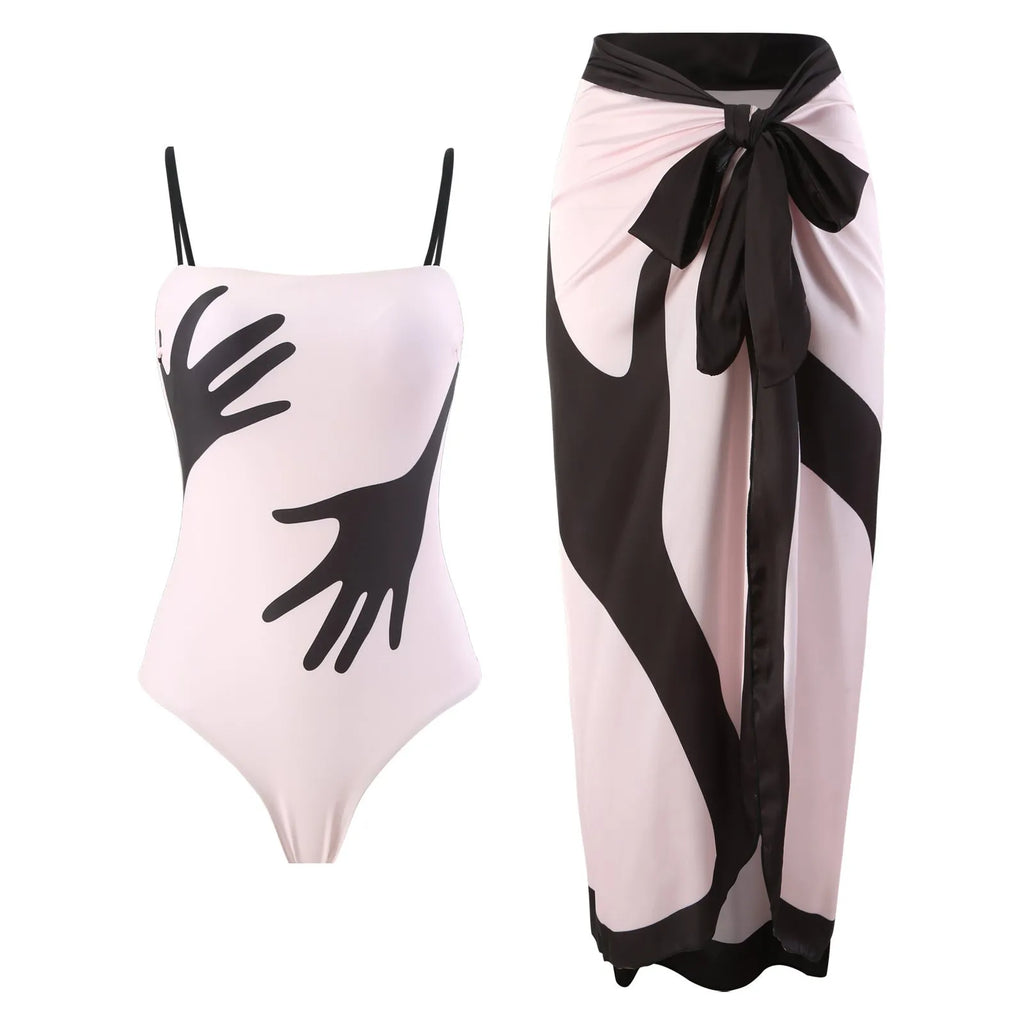 Women's patterned one-piece bikini swimsuit with a separate white tulle skirt laid flat.