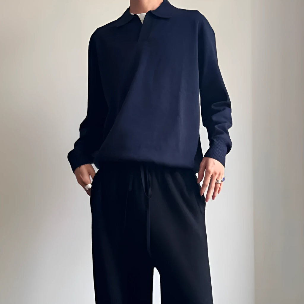Men's navy blue loose fit wool polo sweater with a lapel collar on a hanger.