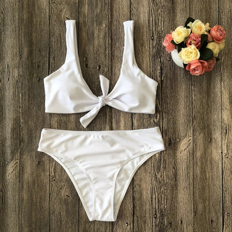 Women's solid colour bikini swimsuit set in polyester fabric, shown in black, pink, red, white, or wine red.