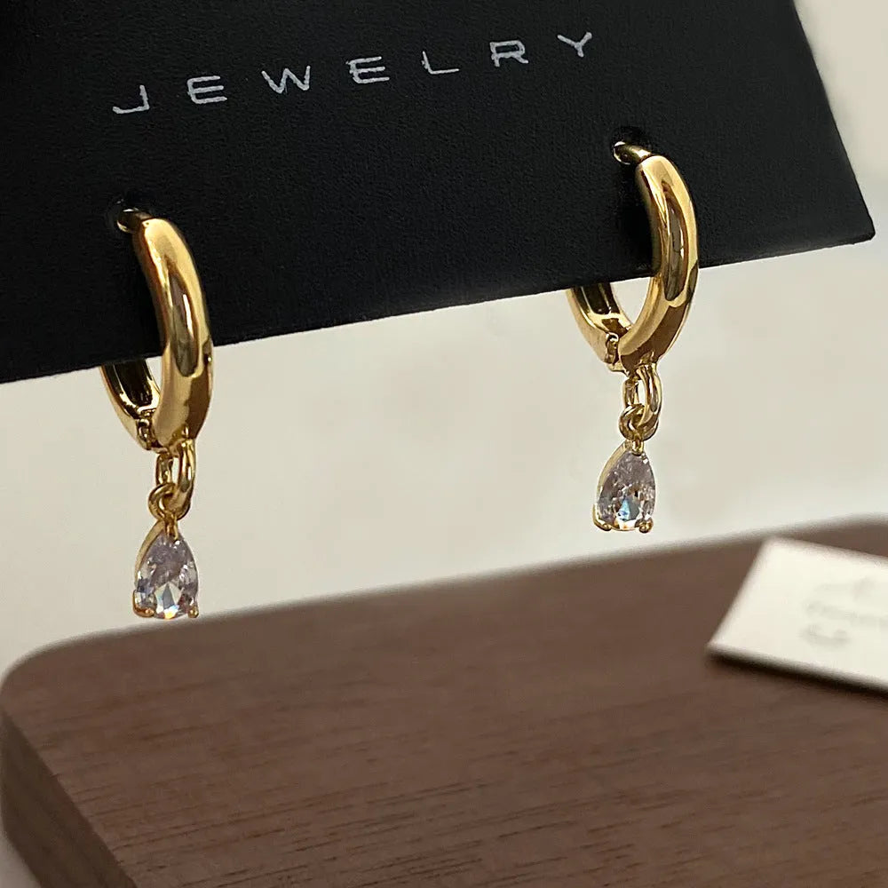 Women's zircon jewellery set showing geometric meteor shower necklace, earrings, and anklet