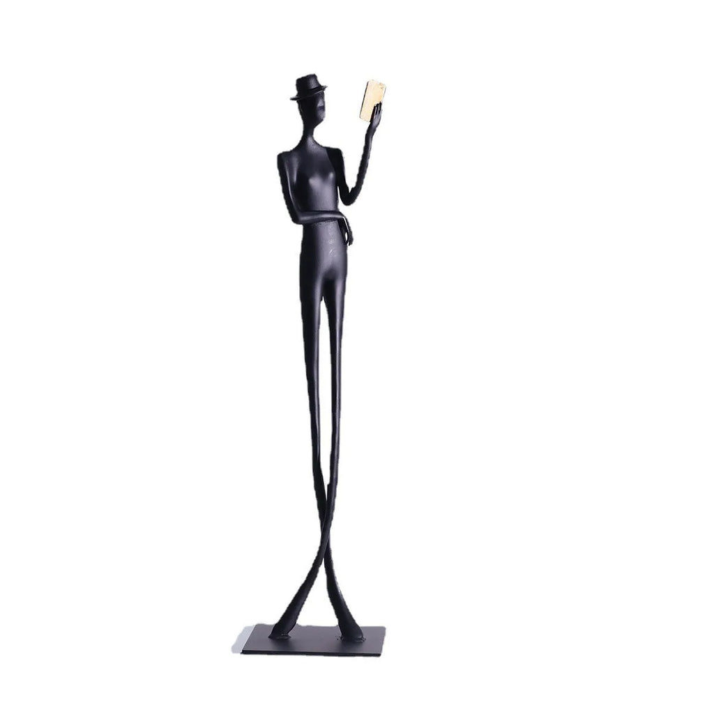 Black cast aluminium desktop sculpture of reading woman figure measuring 12x51cm in modern minimalist style.