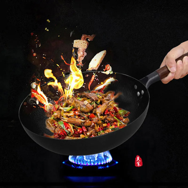 Traditional black iron wok with wooden handle measuring 32cm in diameter