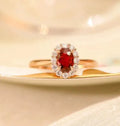 Women's sterling silver ring with gold pigeon design and red gemstone inlay on floral patterned band