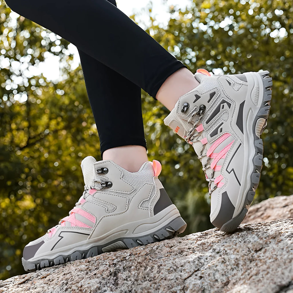 High-top hiking sneakers in multiple colours with flannel uppers and rubber soles on a rocky path.