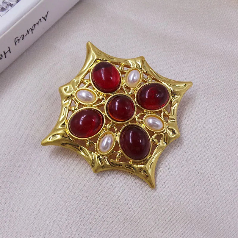 Classic vintage zinc alloy brooch with baroque-style cross design and crystal details on a dark background.