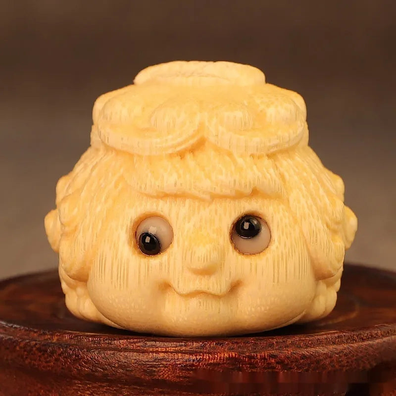 Golden Toad Princess ornament carved from solid bamboo on a wooden surface.