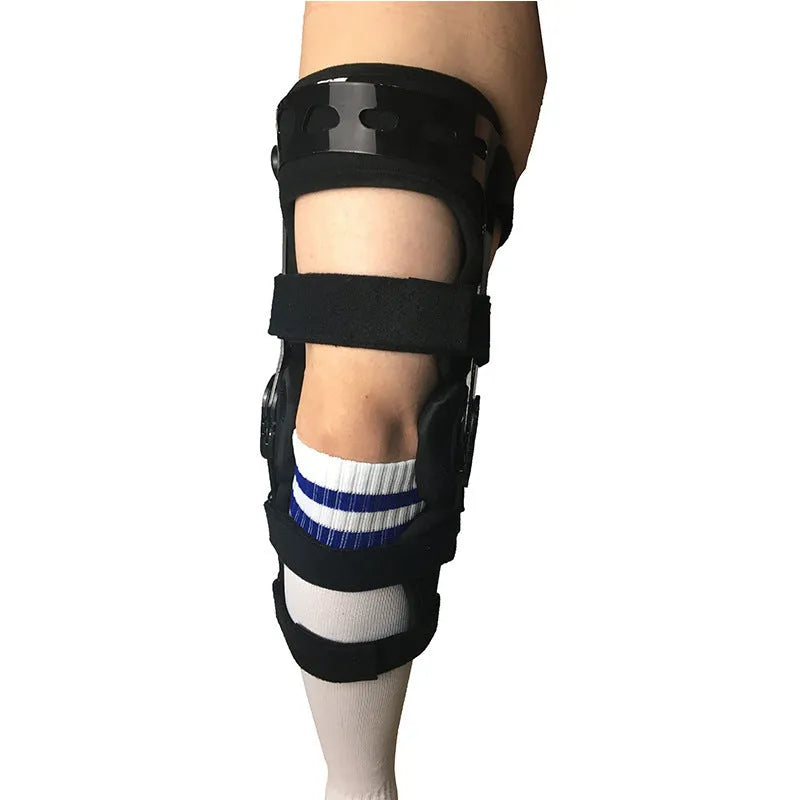Black anterior ligament knee pad showing multi-material construction and sizing tags for left and right knees.