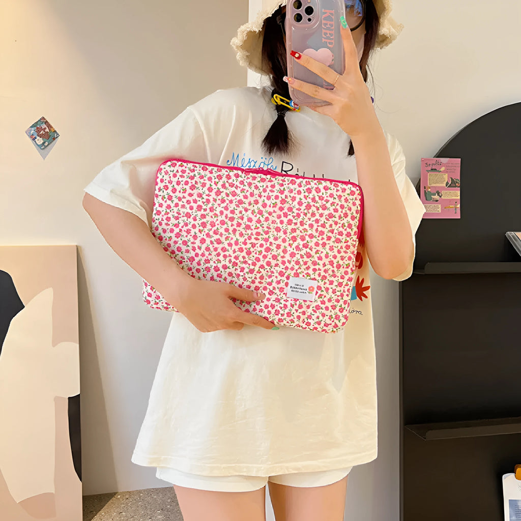 Printed cloth laptop bag for women shown in floral and heart patterns, available in small, medium, and large sizes.