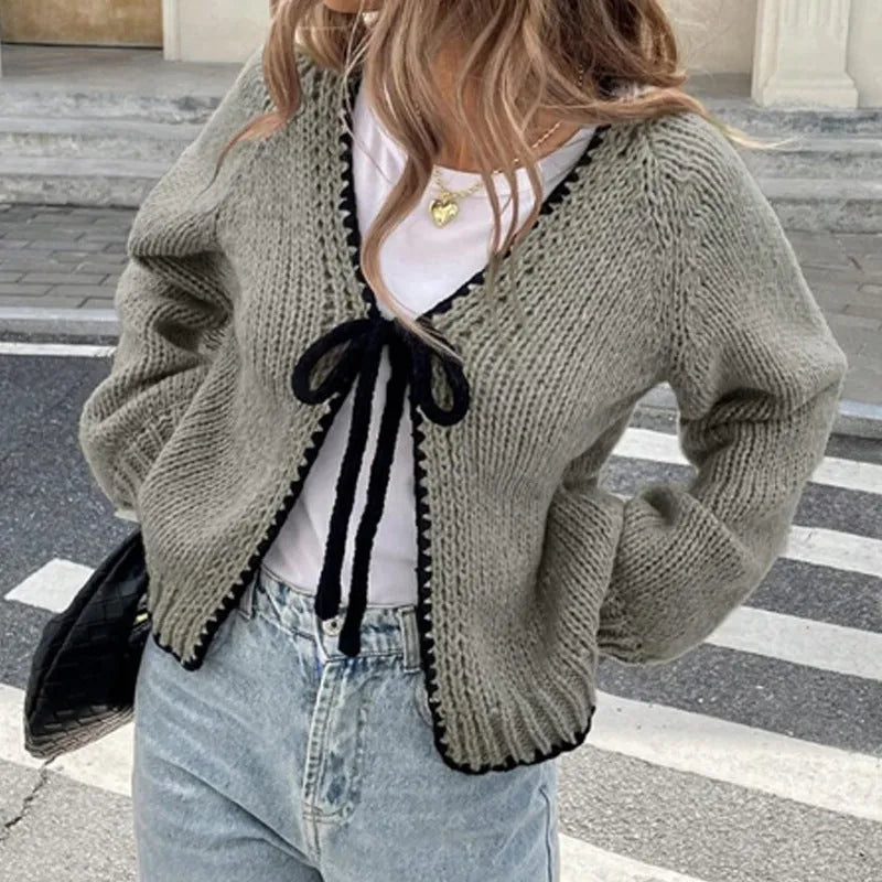 Grey loose-fit lace-up cardigan with long sleeves and a crochet flower detail on the front.