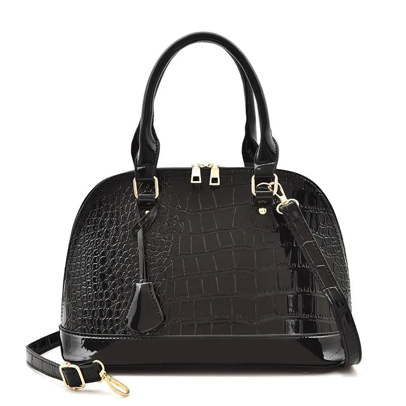 Large shiny PU leather crossbody bag in shell shape design showing black colour option