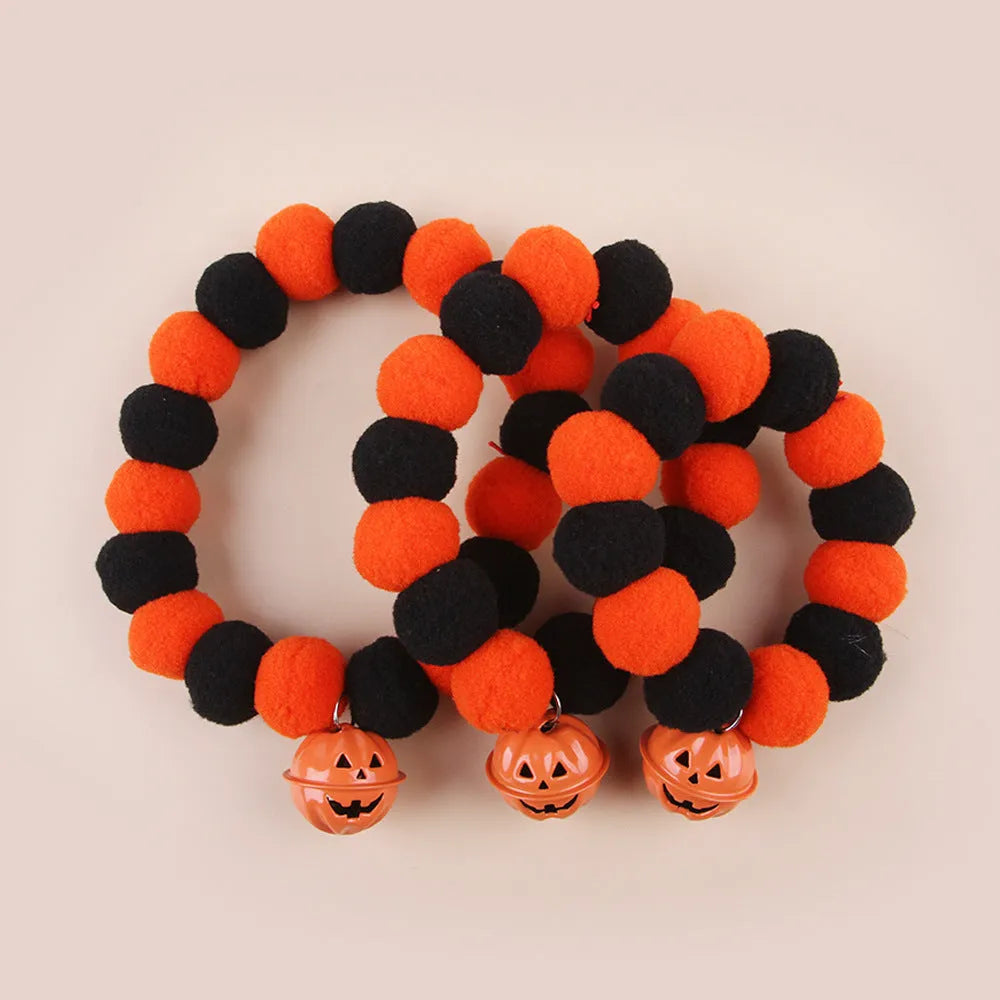 A pumpkin-themed adjustable cat collar for Halloween, shown in three sizes.