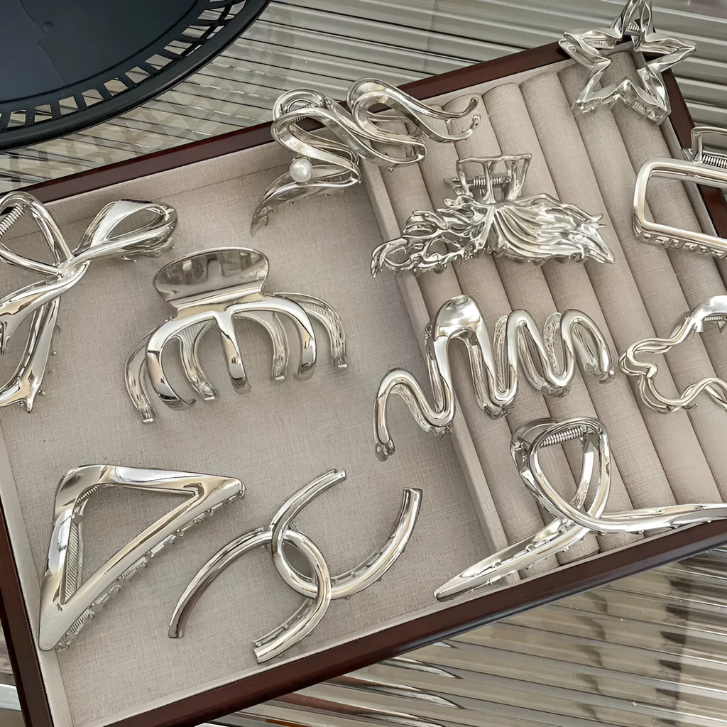 Silver metal hair clips collection with various Korean style designs including bows, pearls, and wave patterns